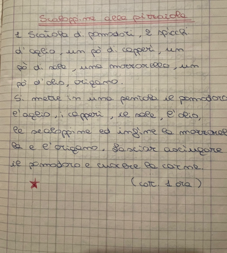 Photo of a handwritten Italian recipe on beige squared notebook paper. The title is written in red ink at the top, the ingredients and instructions are written in dark blue pen below, and a small red star is drawn near the bottom left of the page.